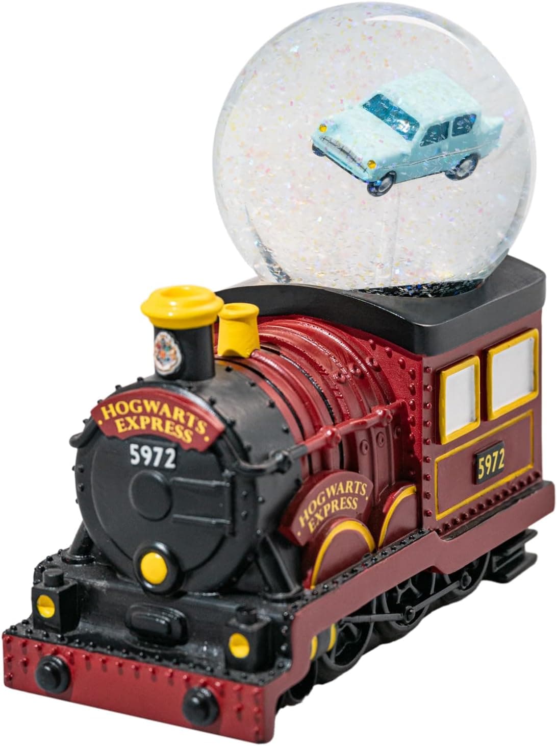Locomotora roja y negra del Expreso de Hogwarts con una bola de cristal encima en la que flota el coche azul volador
