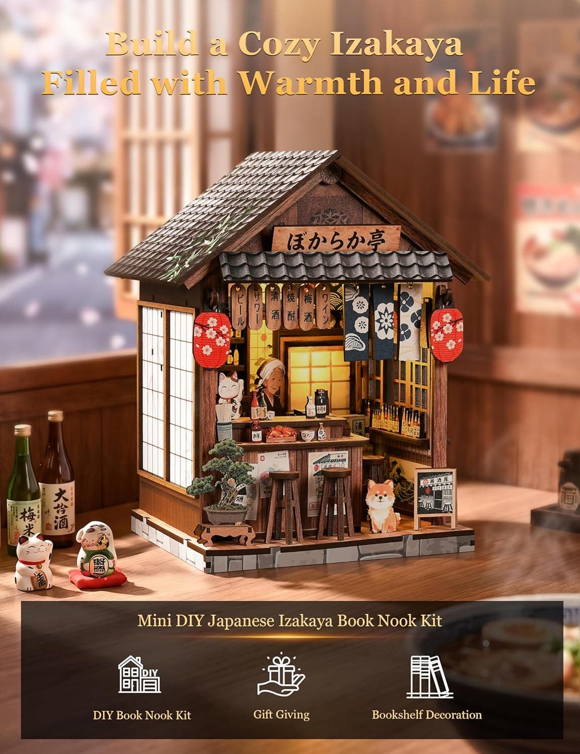 La izakaya en miniatura encendida, con el gato de la suerte, el bonsái y los taburetes de la barra