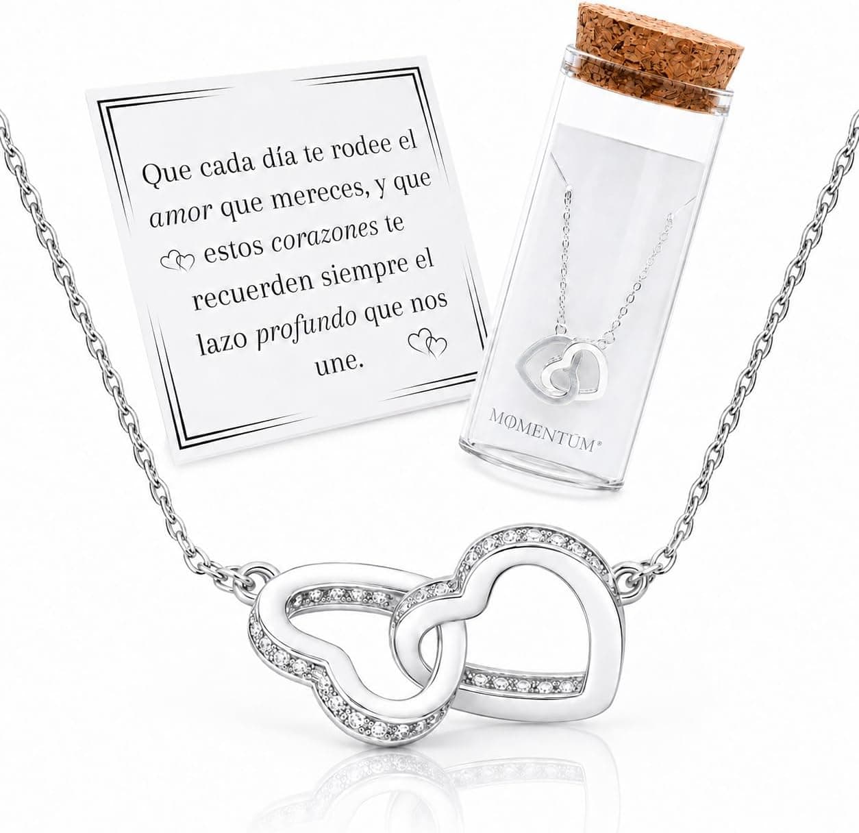 Colgante de dos corazones entrelazados con circonitas en baño de plata, dentro de un tubo de cristal con tapón de corcho y tarjeta con mensaje
