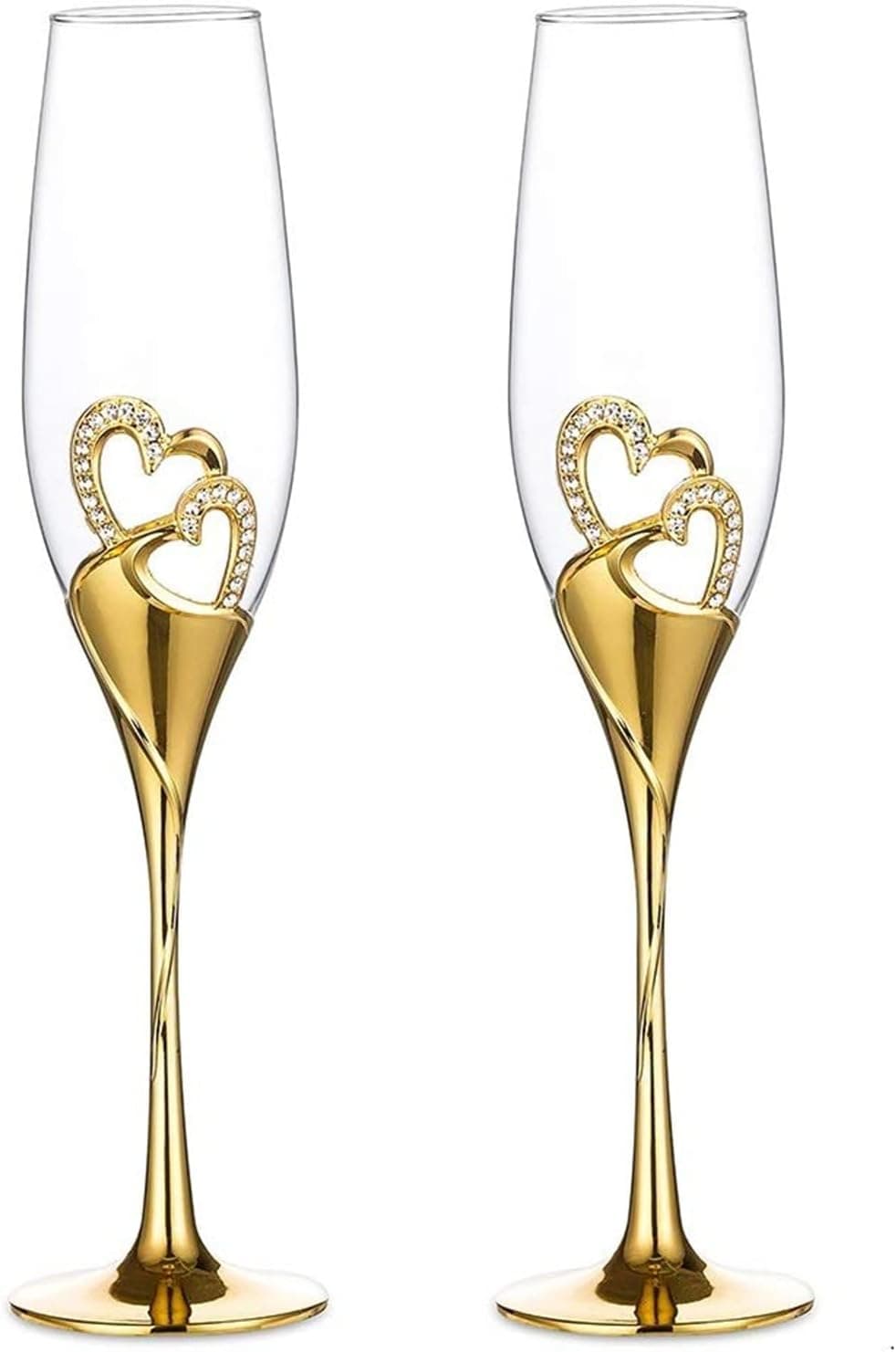 Dos copas de cristal doradas con un adorno en forma de corazón en el tallo