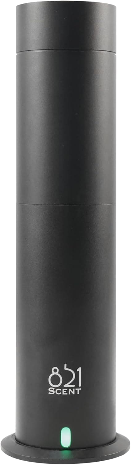 Difusor cilíndrico negro mate, de líneas altas y minimalistas, con un piloto de luz verde en la base