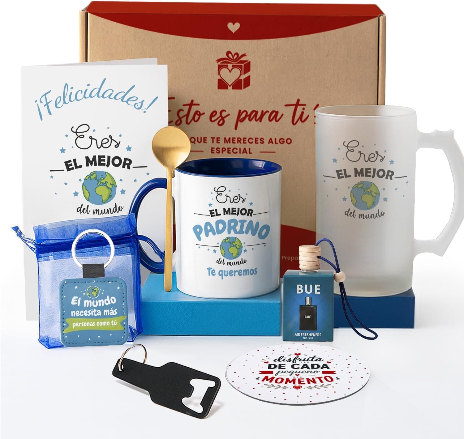 Caja de regalo con tapa roja abierta mostrando una tarjeta «¡Felicidades! Eres el mejor del mundo», una taza azul con «eres el mejor padrino del mundo, te queremos», una cuchara dorada, un llavero en bolsa de organza, un ambientador de coche, una jarra de cristal esmerilado y un llavero abridor negro