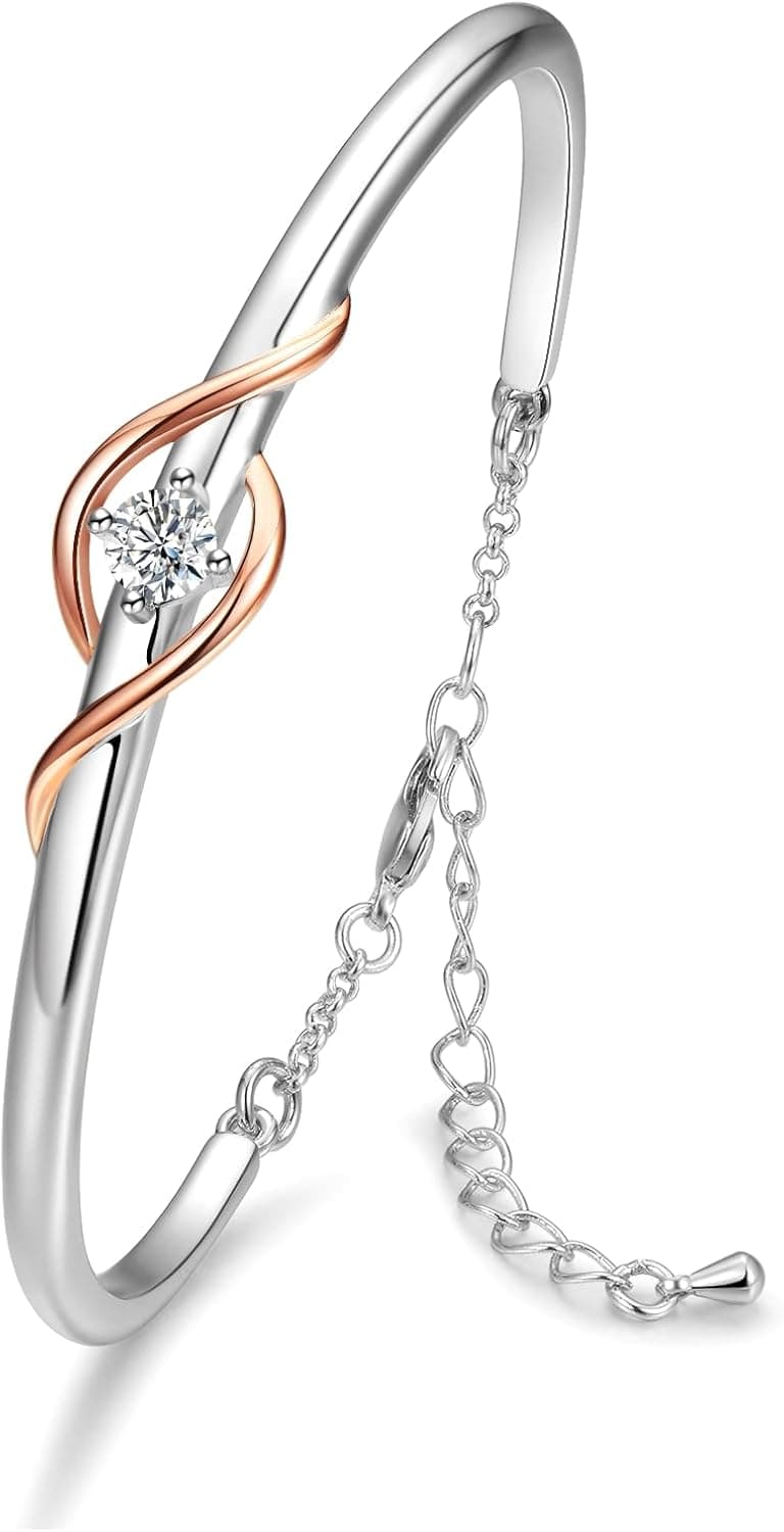 Brazalete rígido en plata y oro rosa con un entrelazado en forma de infinito y una circonita central