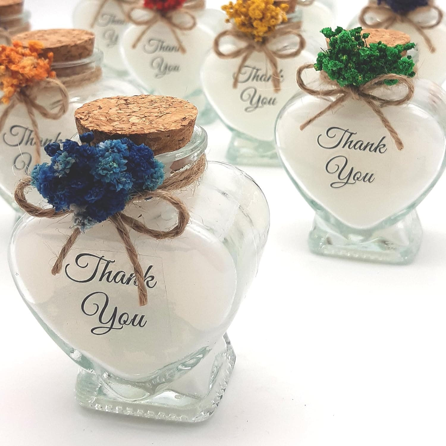 Botella de cristal con vela y flores secas de tonos azules, personalizada con el texto Thank You