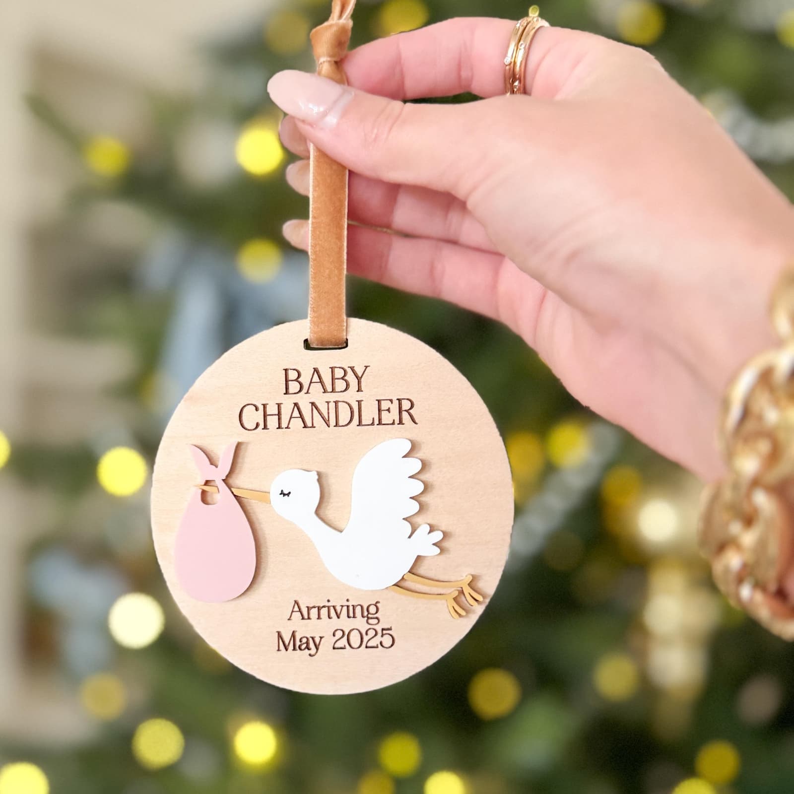 Layered wood and acrylic baby announcement ornament. Personalize with baby’s last name and arrival month and year. Features a white acrylic stork and customize with your choice of acrylic color for stork bag.