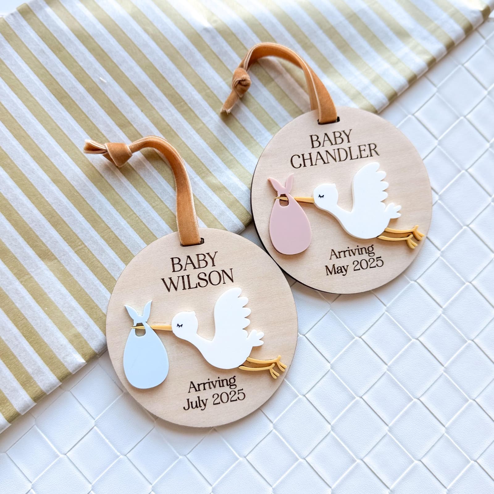 Layered wood and acrylic baby announcement ornament. Personalize with baby’s last name and arrival month and year. Features a white acrylic stork and customize with your choice of acrylic color for stork bag.