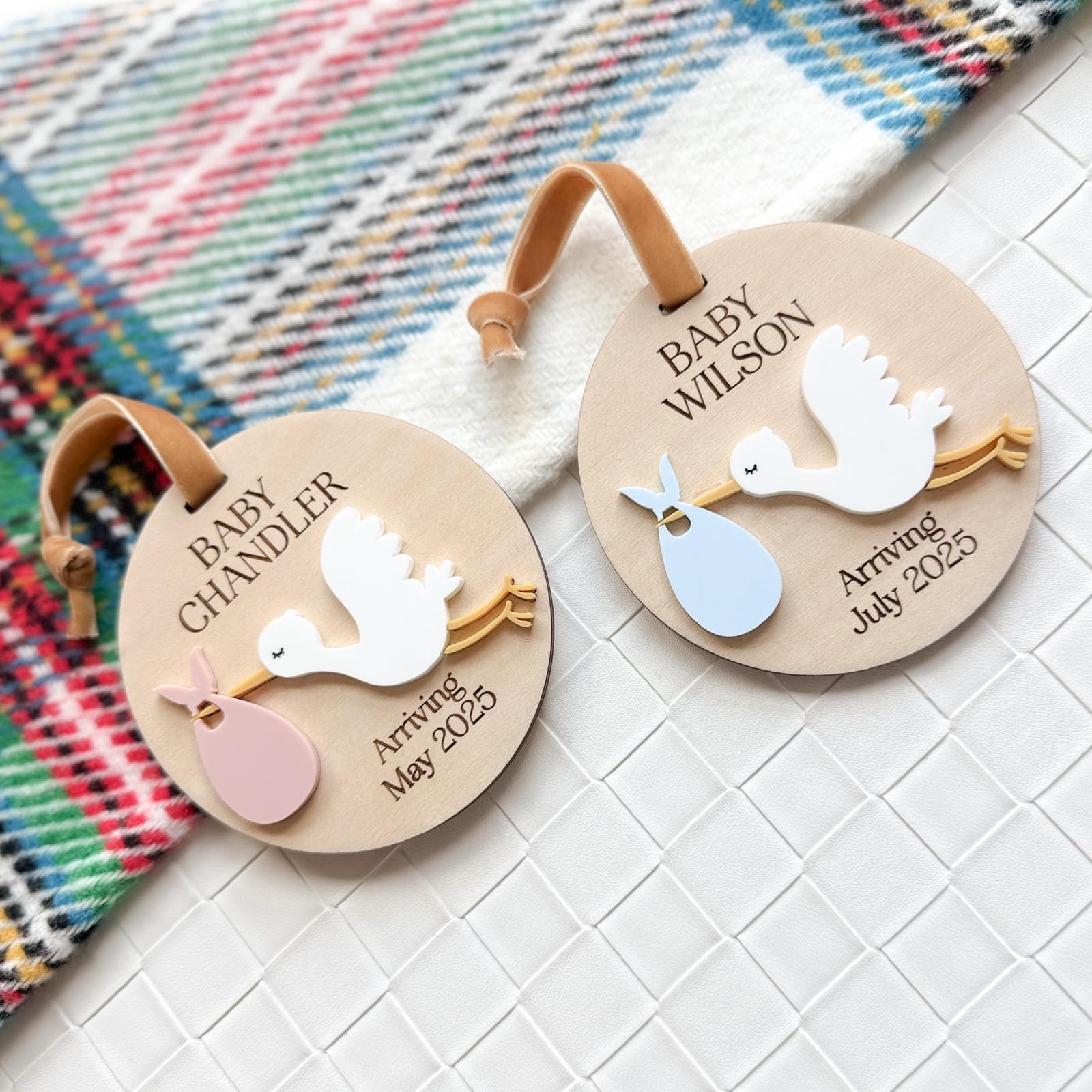 Layered wood and acrylic baby announcement ornament. Personalize with baby’s last name and arrival month and year. Features a white acrylic stork and customize with your choice of acrylic color for stork bag.