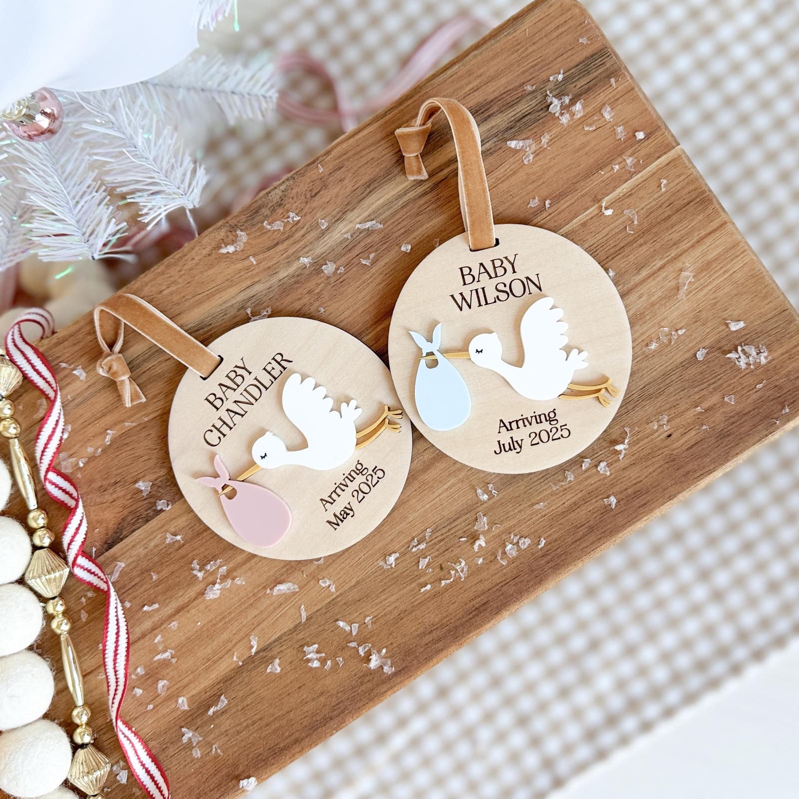Layered wood and acrylic baby announcement ornament. Personalize with baby’s last name and arrival month and year. Features a white acrylic stork and customize with your choice of acrylic color for stork bag.