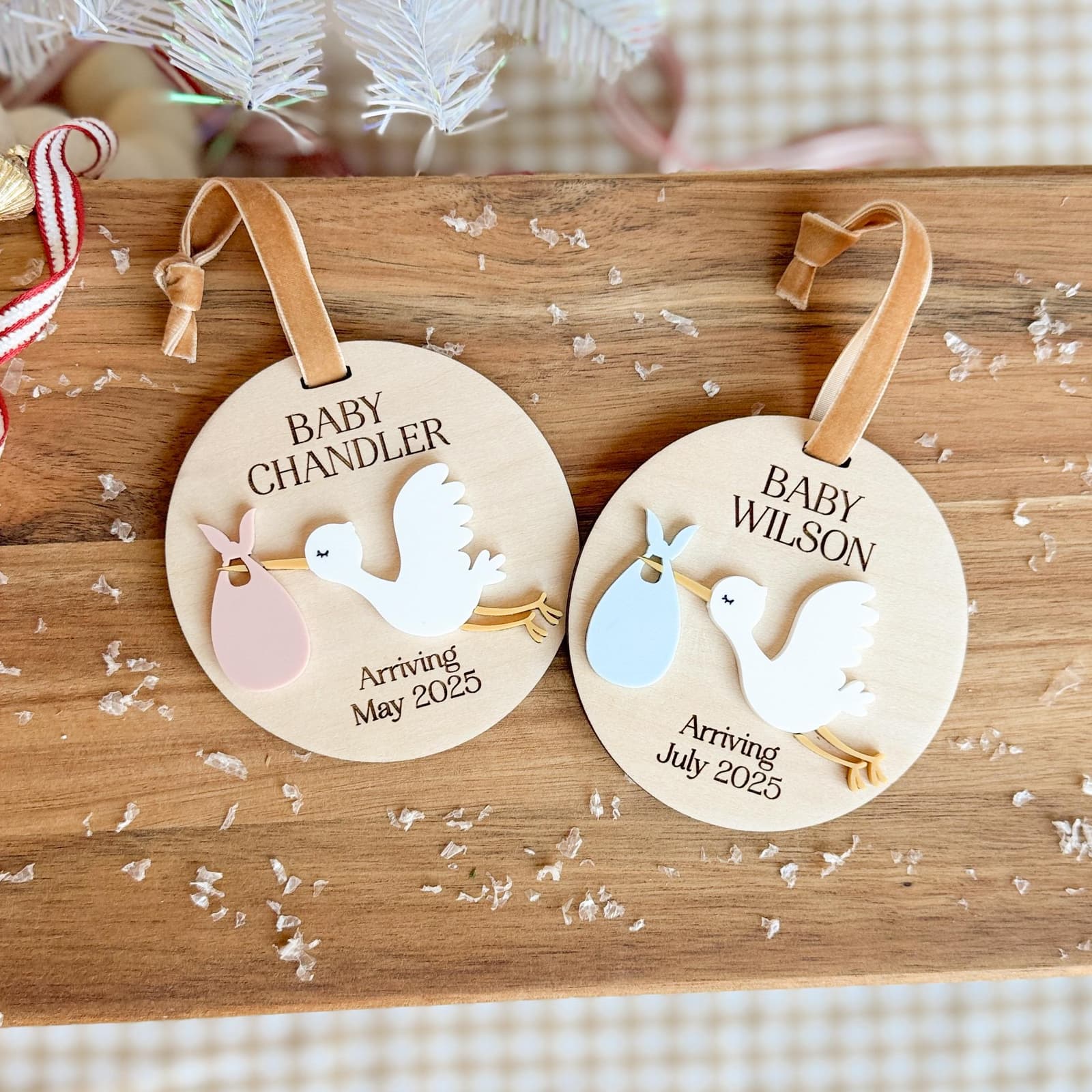Layered wood and acrylic baby announcement ornament. Personalize with baby’s last name and arrival month and year. Features a white acrylic stork and customize with your choice of acrylic color for stork bag.