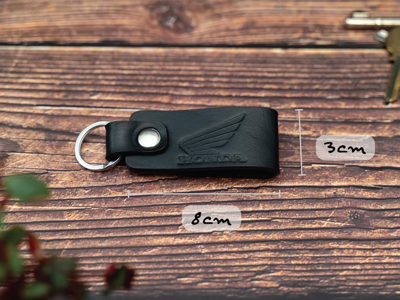 Folded black keyring/keychain embossed with the Honda motorbike logo. Stainless steel split ring and rivet. Dimensions 8cm by 3cm wide