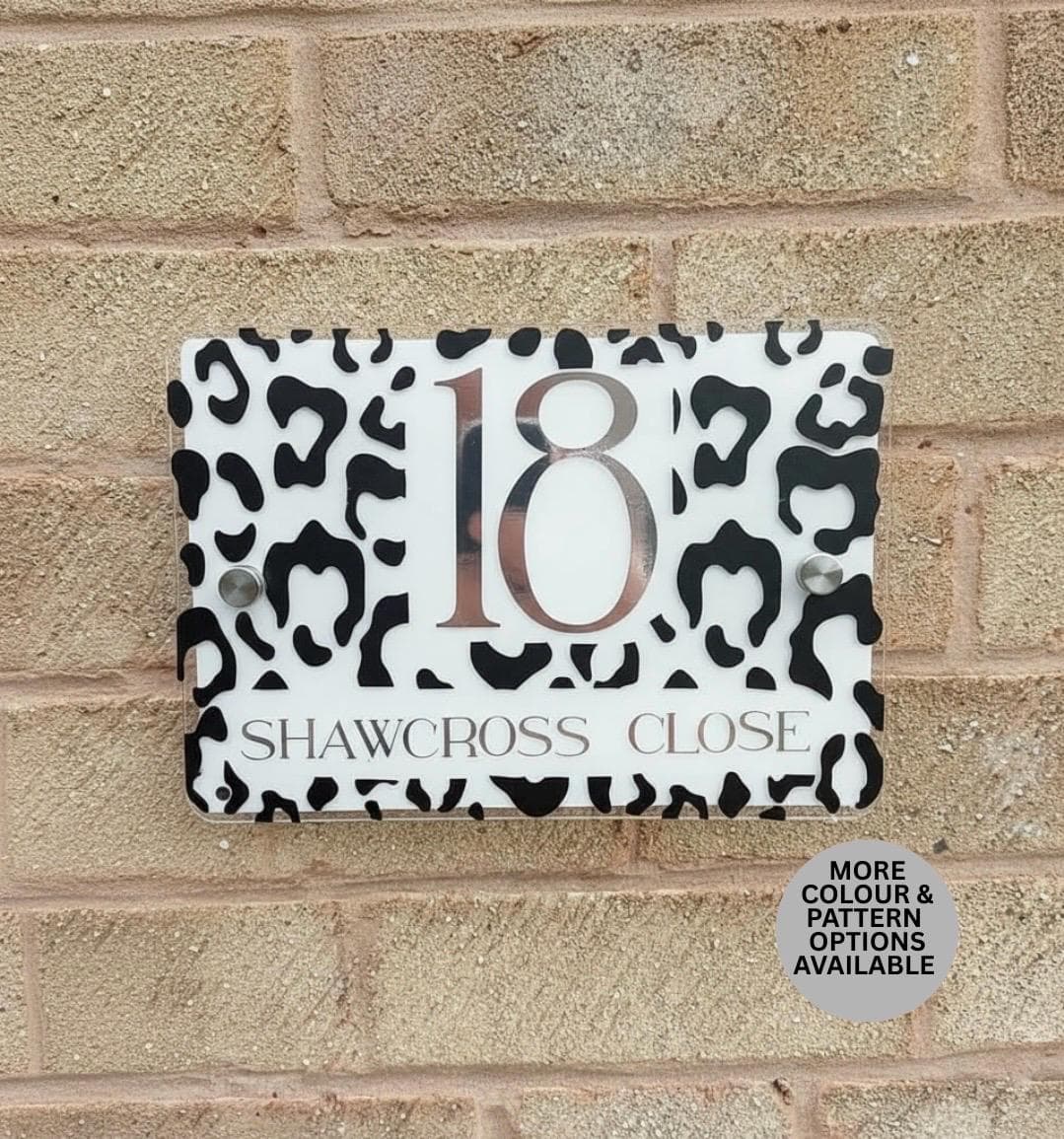 Custom patterned address sign with house number and street name on a modern plaque