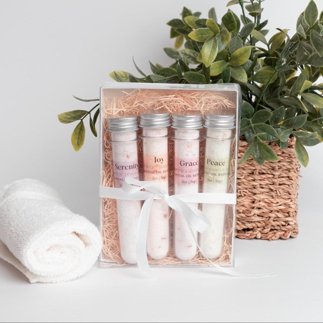 Handmade essential oil bath soak gift set from Megan’s Pantry includes four 2 oz tubes in signature scents: Serenity, Joy, Grace, and Peace. Made with natural salts and organic essential oils, beautifully packaged in a kraft gift box with pine shred and ribbon. Perfect spa-inspired gift for birthdays, showers, or relaxing self-care rituals.