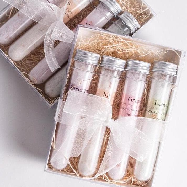 Handmade essential oil bath soak gift set from Megan’s Pantry includes four 2 oz tubes in signature scents: Serenity, Joy, Grace, and Peace. Made with natural salts and organic essential oils, beautifully packaged in a kraft gift box with pine shred and ribbon. Perfect spa-inspired gift for birthdays, showers, or relaxing self-care rituals.