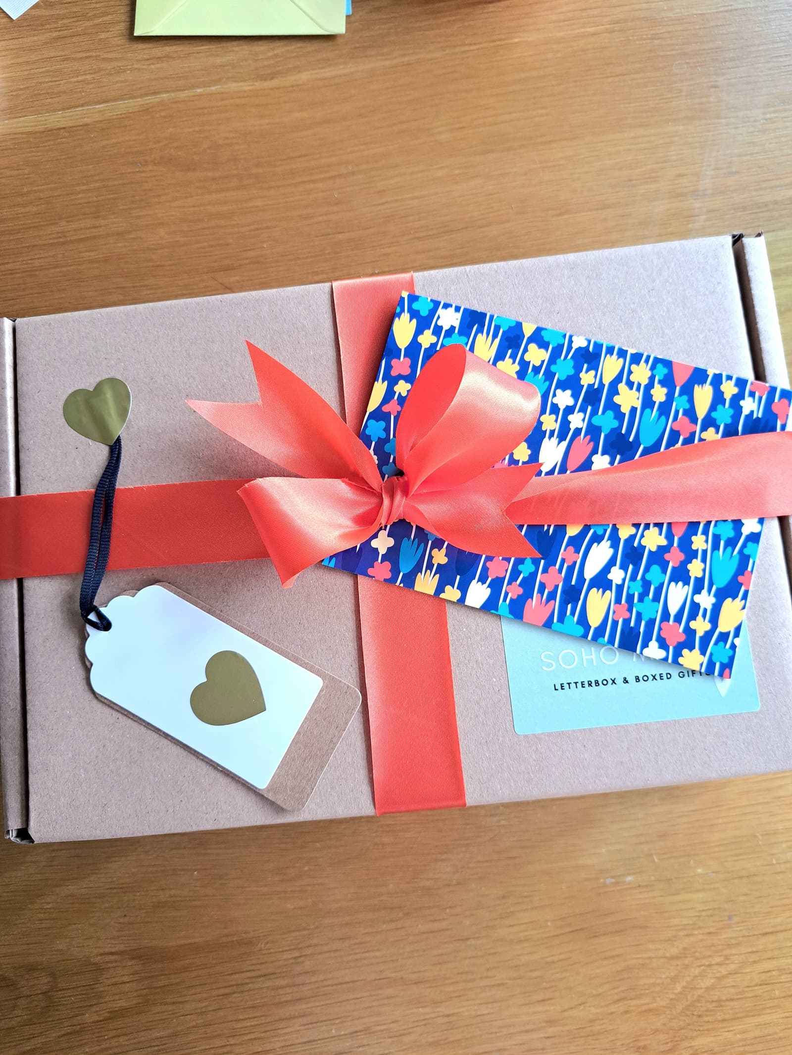 Finished box with ribbon tied in a bow, gift tag and personalised greetings card of choice