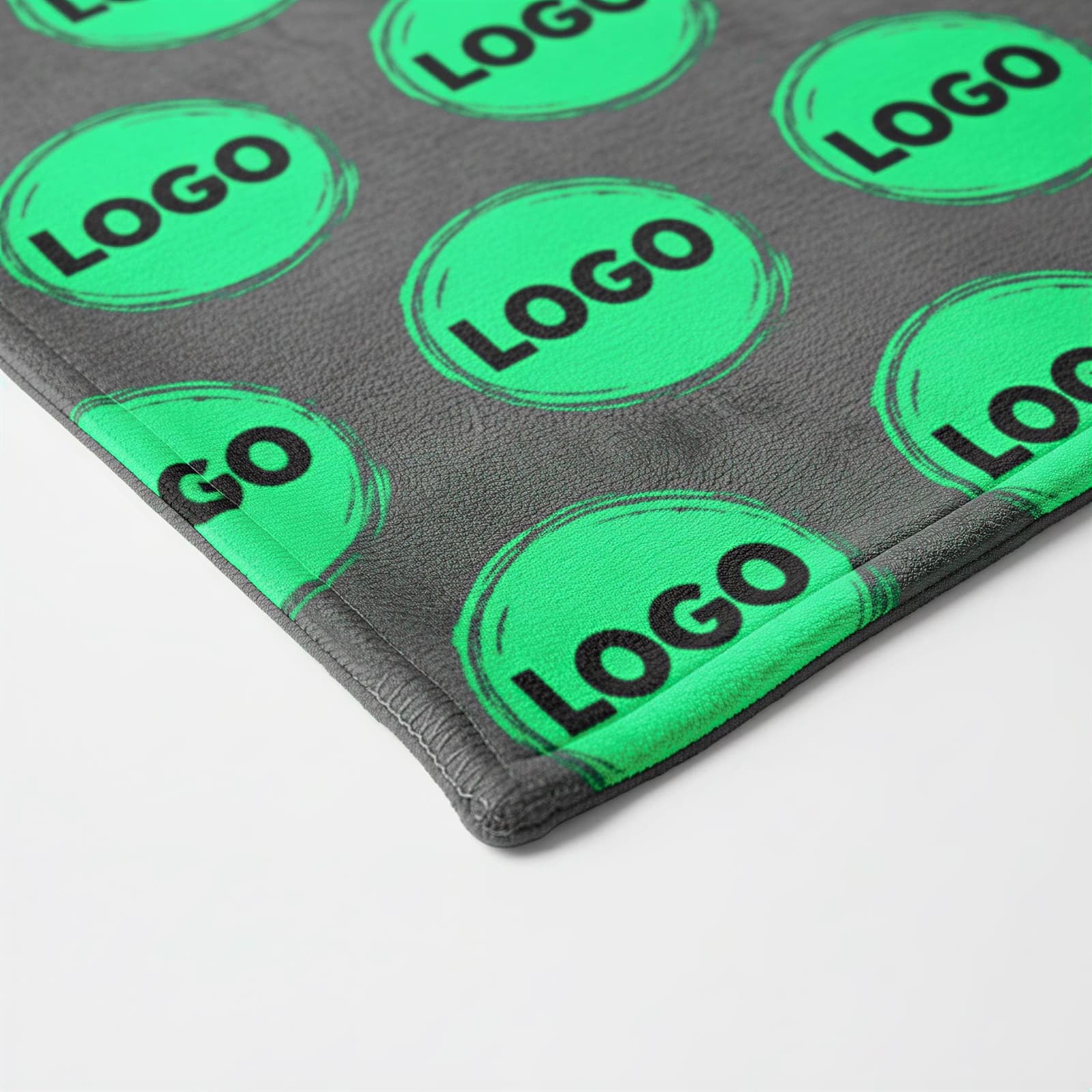 a gray surface with a repeating pattern of green circles containing the word "LOGO" written in black.