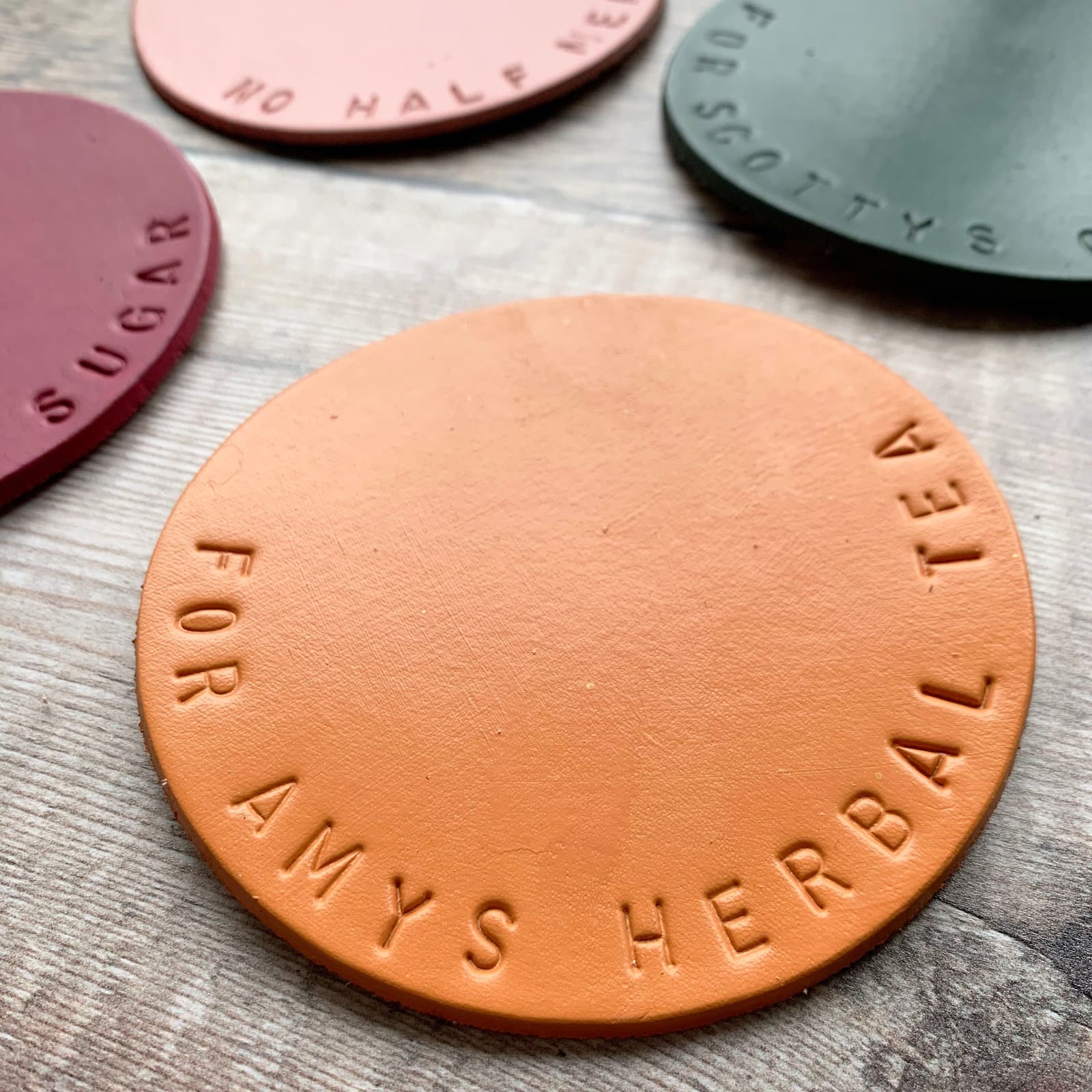 Hand stamped leather coasters. Personalised to order in a variety of colours. Mustard, Olive, Terracotta, Raspberry and Navy blue.