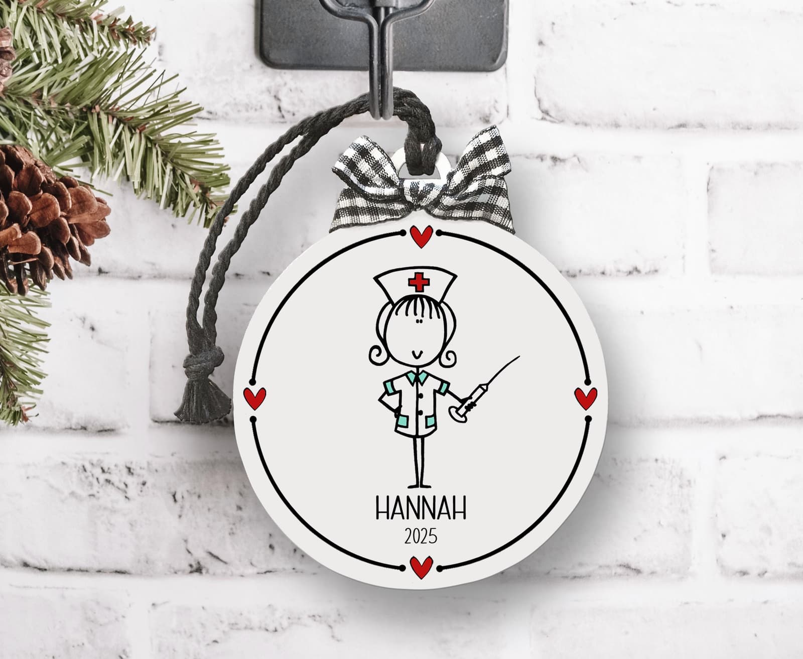 Custom Nursing ornament with whimsical drawing & name and date. White flat round 3" ornament with black lettering and red hearts, checked bow & string hanging cord. Whimsical design, personalized nurse thank you keepsake gift!