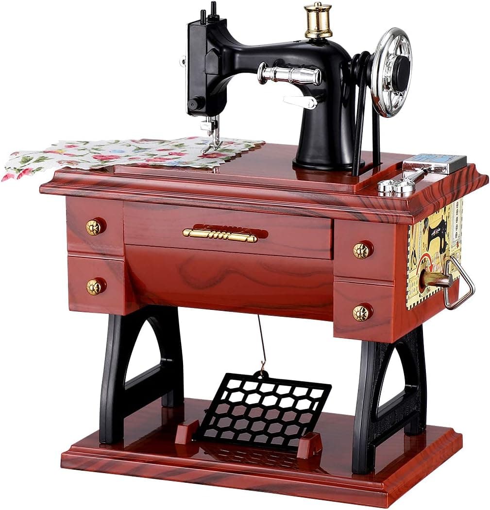 Caja de música con una máquina de coser en miniatura de estilo retro
