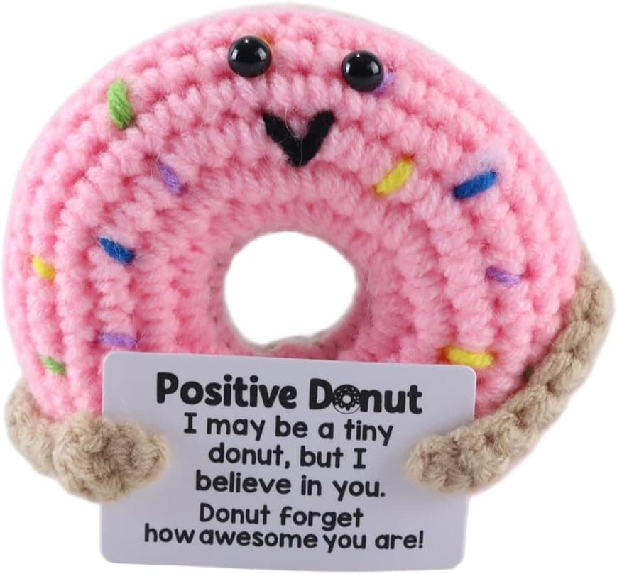 Donut de ganchillo rosa con virutas de colores y una tarjeta con el mensaje en inglés