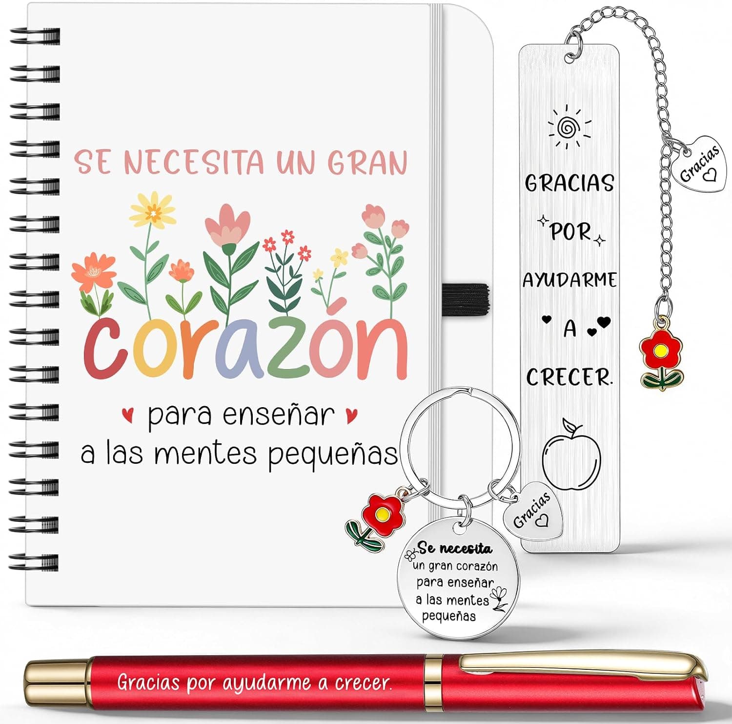 Cuaderno espiral con flores y el mensaje "Se necesita un gran corazón para enseñar a las mentes pequeñas", junto a un marcapáginas, un llavero floral y un bolígrafo rojo, todos con la frase "Gracias por ayudarme a crecer"