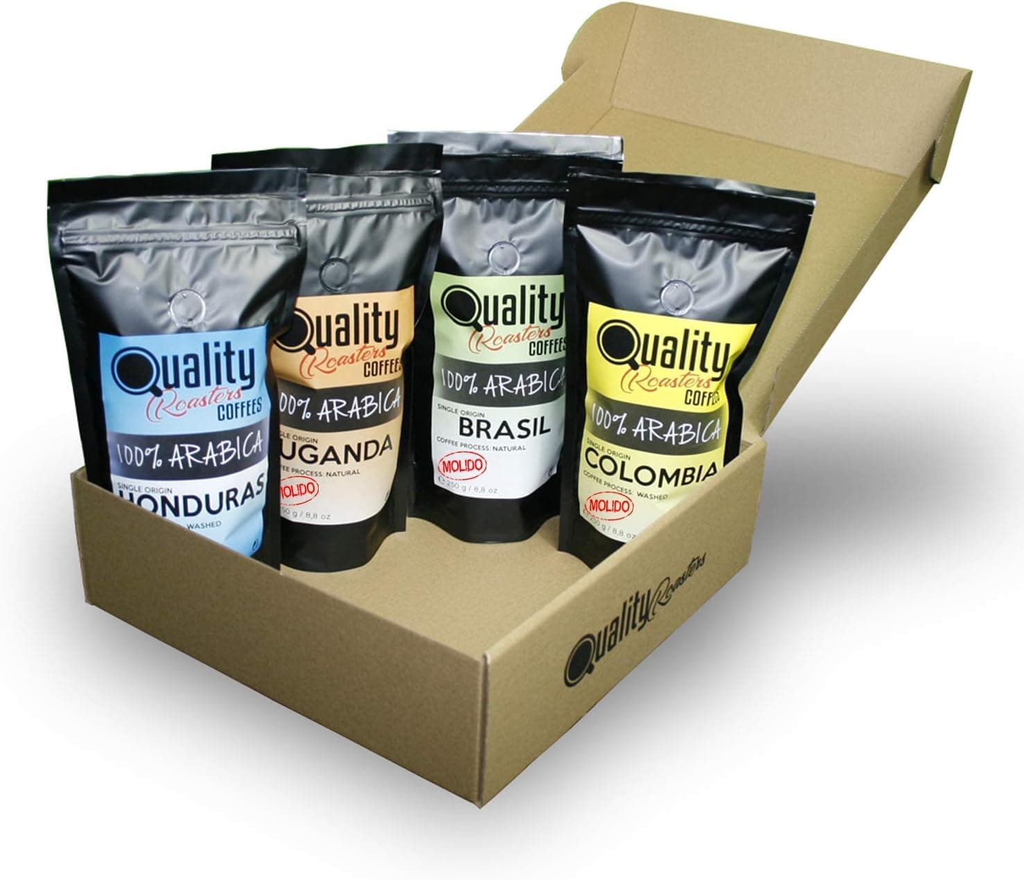 La caja de cartón abierta con los cuatro paquetes negros de café, cada uno de un color y país distintos