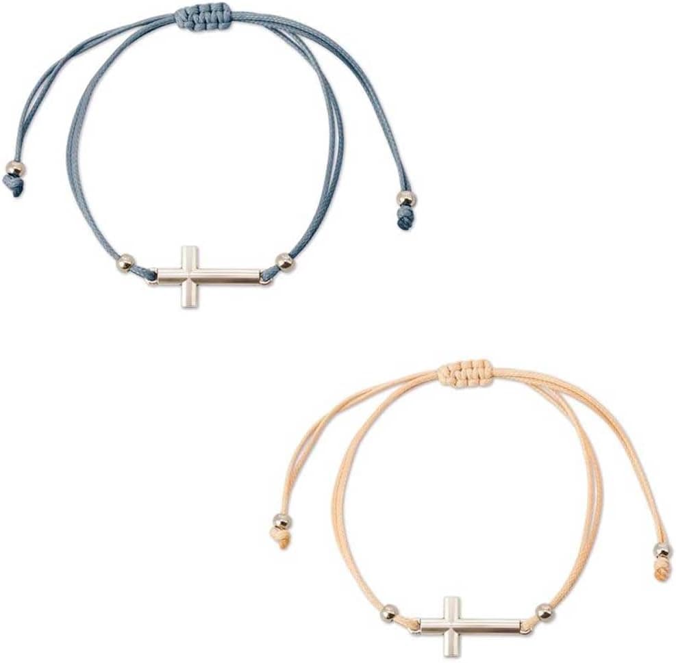 Dos pulseras de tela ajustables, una gris y otra beige, cada una con una cruz metálica como colgante central