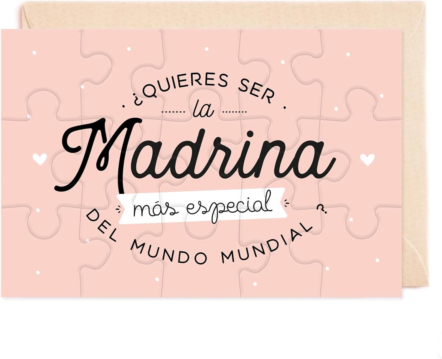 Puzle rectangular rosa empolvado de quince piezas con «¿quieres ser la madrina más especial del mundo mundial?» en letra manuscrita negra, con el sobre kraft detrás