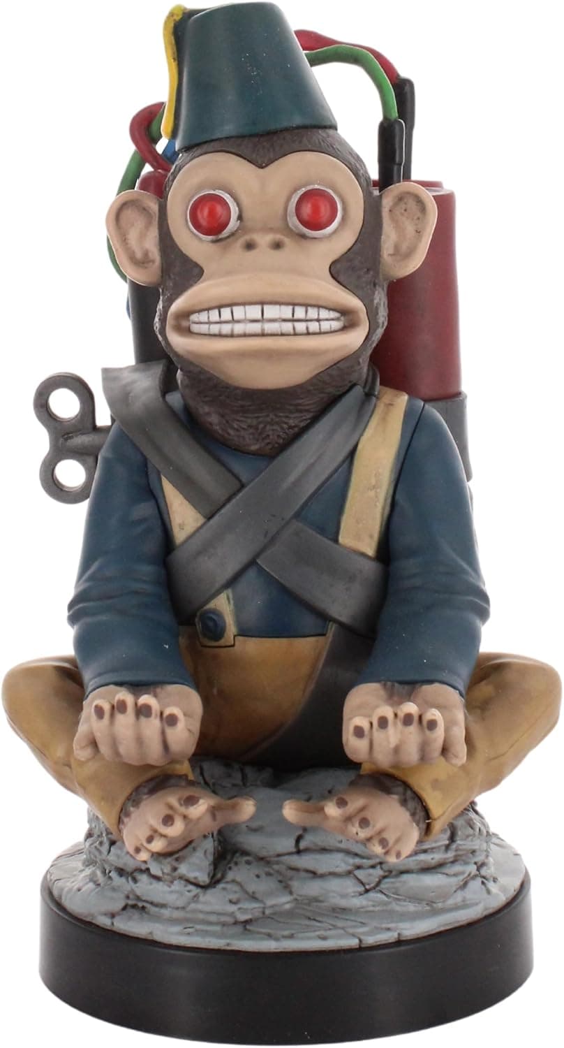 Figura soporte con forma de Monkey Bomb de Call of Duty, sujetando un mando y un móvil