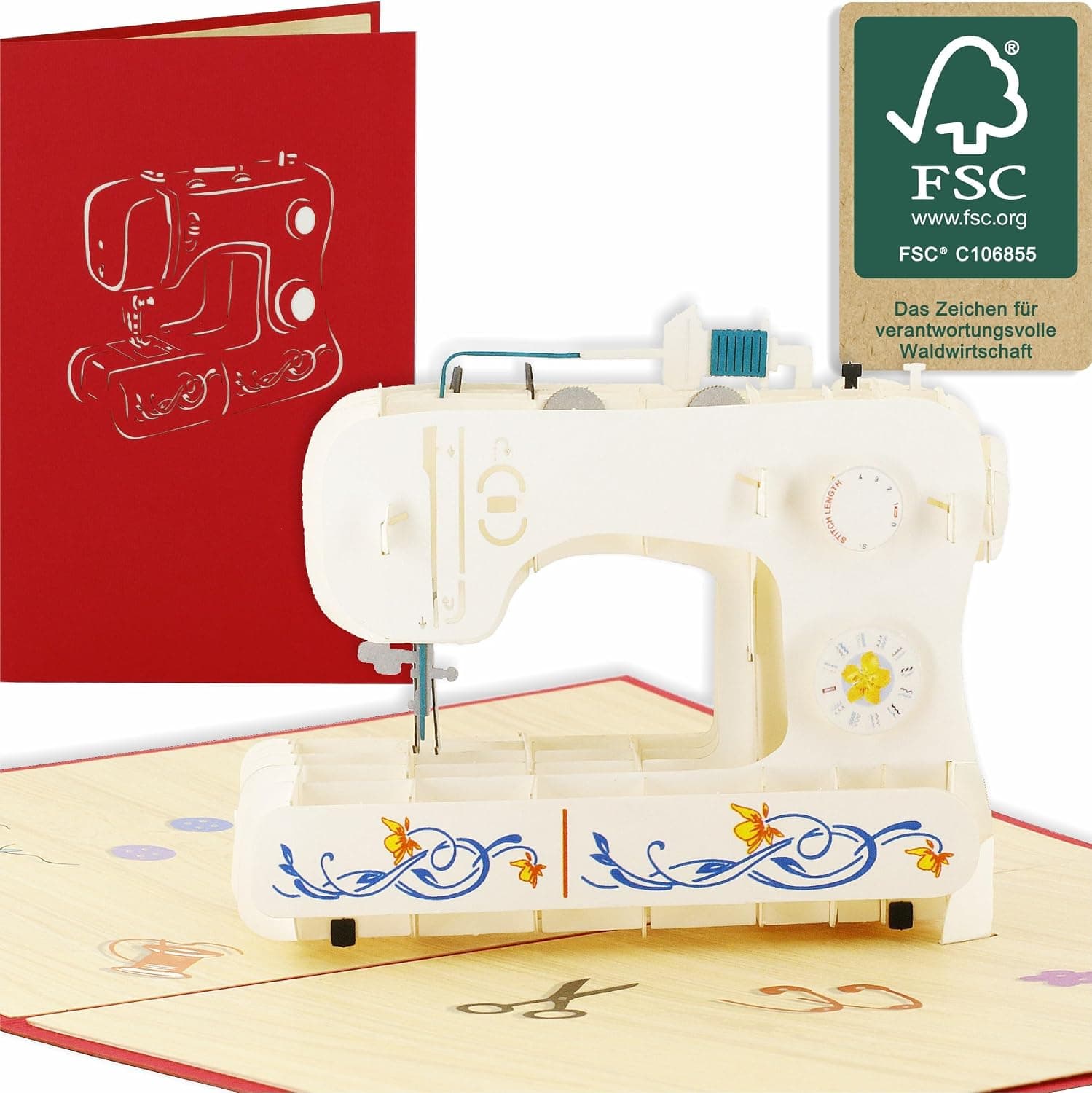 Tarjeta de felicitación que se abre en una máquina de coser en miniatura de papel